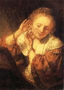 REMBRANDT Harmenszoon van Rijn Young Woman Trying on Earrings oil painting artist
